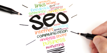 An illustrated light bulb with SEO-related phrases drawn on it, symbolizing search engine optimization concepts